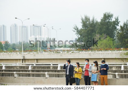Red alert for air pollution: people on the street wearing protective masks