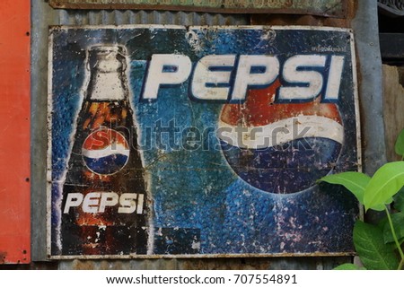 Ratchaburi, Thailand - July 9,2017 : Rust old wall vintage logo of soft drinks advertising metal board sign