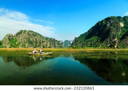 Landscape with boat in Van Long natural reserve in Ninh Binh, Vietnam