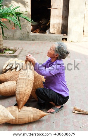 HUNGYEN, VIETNAM - JUNE 21 2015 :Unidentified woman was weaving bamboo in HungYen, Vietnam. Weaving this tools that used to catch fish is traditional occupation in Hung Yen province.