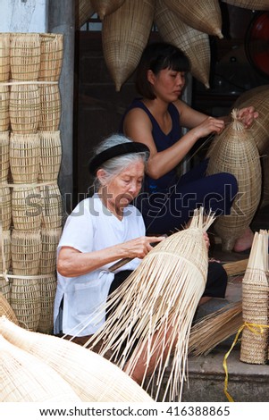 HUNGYEN, VIETNAM - JUNE 21 2015 :Unidentified woman was weaving bamboo in HungYen, Vietnam. Weaving this tools that used to catch fish is traditional occupation in Hung Yen province.