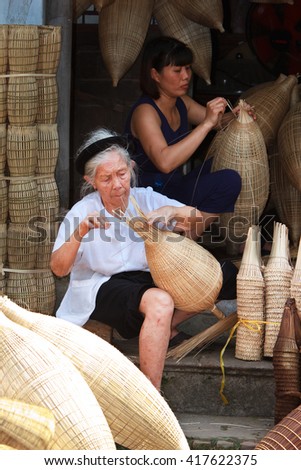 HUNGYEN, VIETNAM - JUNE 21 2015 :Unidentified woman was weaving bamboo in HungYen, Vietnam. Weaving this tools that used to catch fish is traditional occupation in Hung Yen province.