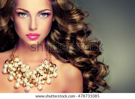 https://thumb7.shutterstock.com/display_pic_with_logo/1054231/478731085/stock-photo--beautiful-model-brunette-with-long-curled-hair-girl-with-big-necklace-with-beads-and-chain-478731085.jpg