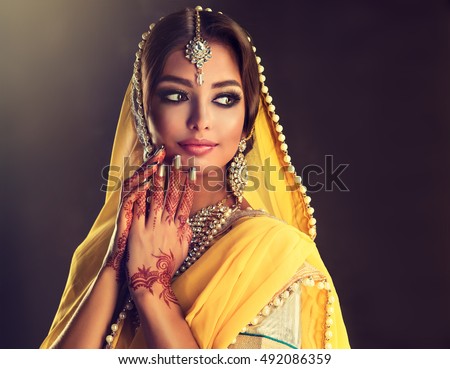 https://thumb7.shutterstock.com/display_pic_with_logo/1054231/492086359/stock-photo-portrait-of-beautiful-indian-girl-young-hindu-woman-model-with-tatoo-mehndi-and-kundan-jewelry-492086359.jpg