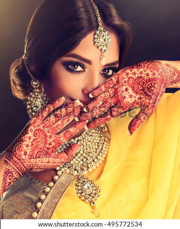 https://thumb7.shutterstock.com/display_pic_with_logo/1054231/495772534/stock-photo-portrait-of-beautiful-indian-girl-young-hindu-woman-model-with-tatoo-mehndi-and-kundan-jewelry-495772534.jpg