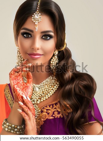 https://thumb7.shutterstock.com/display_pic_with_logo/1054231/563490055/stock-photo-portrait-of-beautiful-indian-girl-young-hindu-woman-model-with-tatoo-mehndi-and-kundan-jewelry-563490055.jpg
