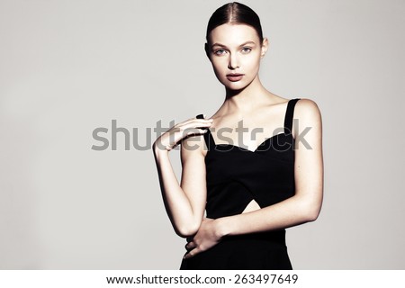 fashion model portrait. beautiful young woman on grey background