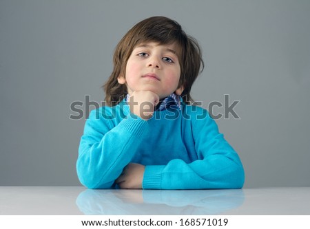 smart beautiful kid thinking against grey background