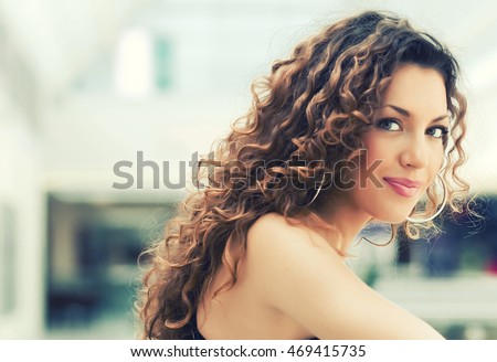 Portrait of beautiful caucasian girl with curly hair