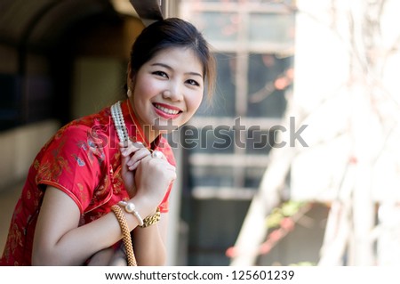 beautiful asian girl in red chinese traditional dress (qipao) - stock photo