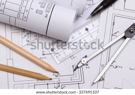 rolls of electrical diagrams and accessories for drawing lying on construction drawing of house drawings rolls of electrical diagrams and accessories for drawing lying on construction drawing of house drawings