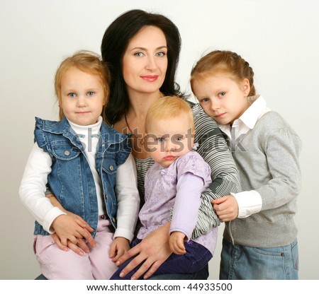 Mother with three daughters on white background