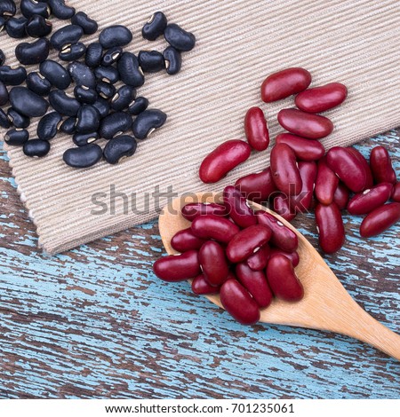 Soy beans, Red beans, black beans, and navy bean on blue wooden background in square format