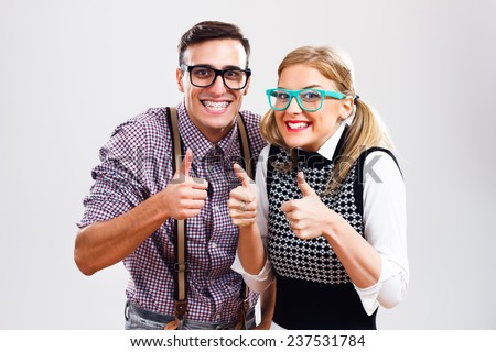 stock-photo-happy-nerdy-couple-showing-thumbs-up-successful-nerds-237531784.jpg