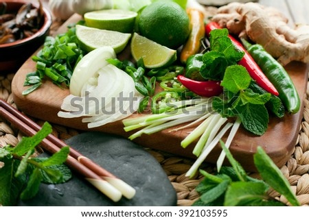 Vietnamese food ingredient board - ginger, chili, lime, spring onion, garlic, shallots, shiitake mushroom, mint, cilantro, coriander. All colorful spices make traditional asian food more delicious.