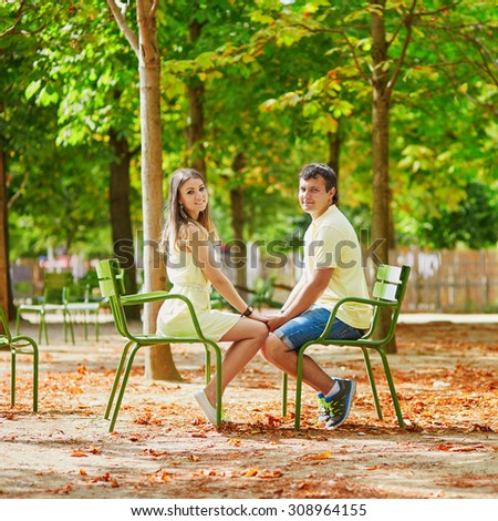 https://thumb7.shutterstock.com/display_pic_with_logo/118180/308964155/stock-photo-romantic-dating-couple-of-tourist-in-paris-in-the-tuileries-garden-sitting-on-traditional-parisian-308964155.jpg