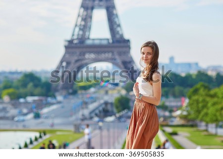 https://thumb7.shutterstock.com/display_pic_with_logo/118180/369505835/stock-photo-beautiful-young-parisian-woman-in-long-brown-silk-skirt-near-the-eiffel-tower-on-a-summer-day-369505835.jpg