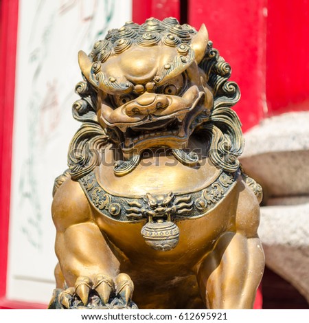 stock-photo-gold-lion-statue-in-chinese-temple-at-china-town-thailand-612695921.jpg