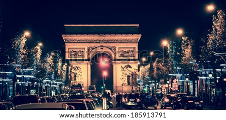 Arch of Triumph and Champs Elysees with Christmas festive illumination. Paris in winter. Toned image.