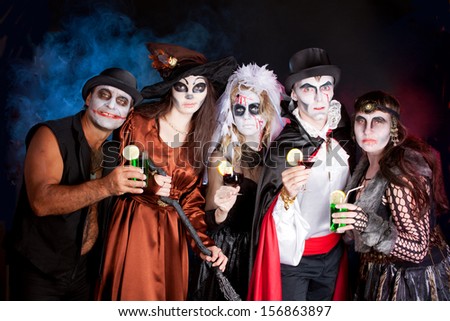 men and women wearing as vampire, witch, dead bride for Halloween