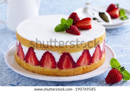 Sponge cake with strawberries and vanilla cream. - stock photo