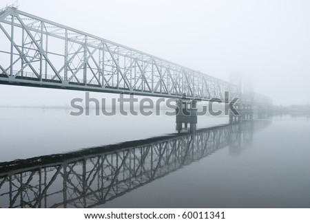 railway bridge through the river.matutinal mist