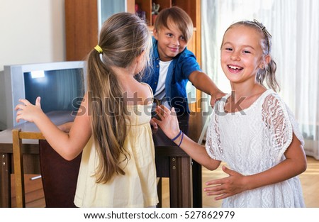 smiling laughing child chasing other kids to tag or touch them