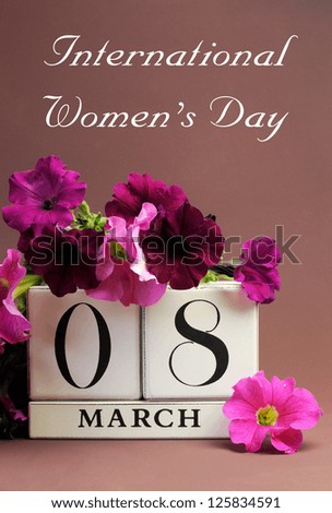 Save the date white block calendar for International Women's Day, March 8, decorated with pink and purple flowers against a pink purple background.