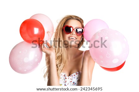Young beautiful woman with glasses holding red pink balloons, valentine's day, isolated