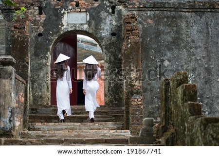HUE, VIETNAM, MAY 3: Vietnamese girls with Ao Dai in Tu Duc royal tomb on May 3, 2014 in Hue, Vietnam. Ao dai is famous traditional custume for woman in VIetnam.