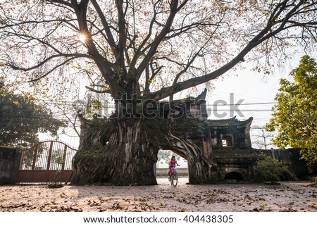 VINHPHUC, VIETNAM, APRIL 10, 2016: Children play near an ancient gate in a village in Vinh Phuc province, Vietnam. Village gate is a specific of Northern country side in Vietnam.