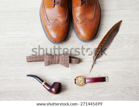 Set of men's clothing and accessories on light gray wooden background