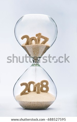 New Year 2018 concept with hourglass falling sand taking the shape of a 2018