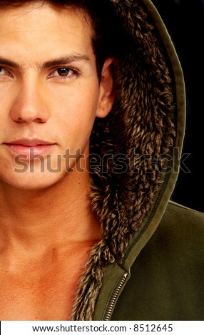 fashion male portrait with a hodded coat over a black background