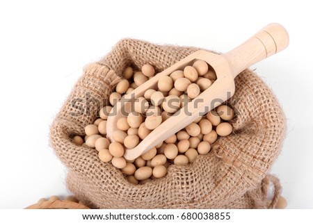 Close up Soy beans on wooden scoop in sack on isolated on white.