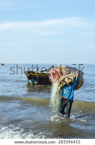 Long Hai, Ba Ria - Vung Tau, Vietnam - 31 May 2015: A fisherman carrying net back home from a long trip at Long Hai, Ba Ria - Vung Tau, Vietnam