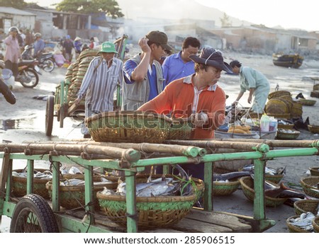Long Hai, Ba Ria Vung Tau, Vietnam 31 May 2015: A man sorting baskets full of fish at Phuoc Hai fish market.