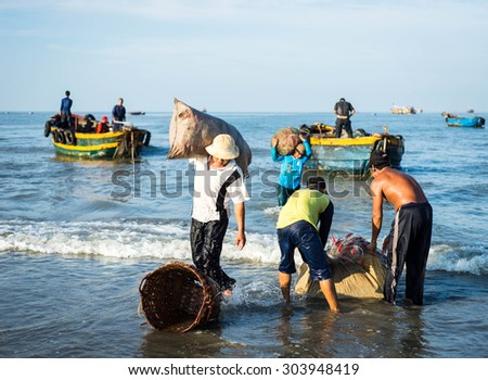 Long Hai, Ba Ria - Vung Tau, Vietnam - 31 May 2015: Fishermen carrying net back home from a long trip at Long Hai, Ba Ria - Vung Tau, Vietnam