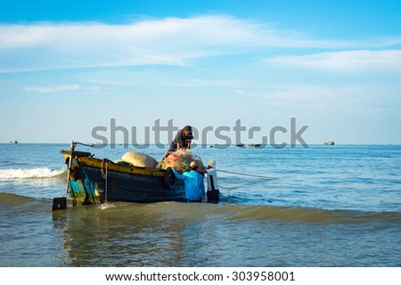 Long Hai, Ba Ria - Vung Tau, Vietnam - 31 May 2015: Fishermen carrying net back home from a long trip at Long Hai, Ba Ria - Vung Tau, Vietnam