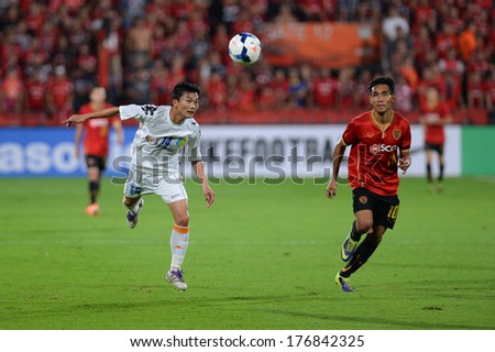 NONTHABURI-FEB 8,Nguyen Hong Tien(W)of Hanoi T&T Jump tackles football during AFC Champions League 2014 between SCG Muangthong utd and Hanoi T&T at SCG Stadium on February8,2014 in Thailand