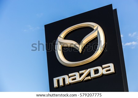 La rochelle, France - August 30, 2016: Official dealership sign of Mazda against the blue sky. Mazda Corporation is a Japanese automotive manufacturer