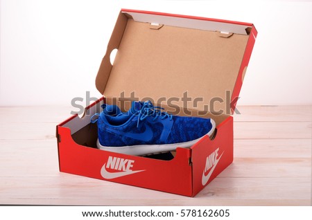 SAMARA, RUSSIA - February 11, 2017: Blue Nike sneakers for running in red box, football, training, showing the Nike logo, illustrative editorial