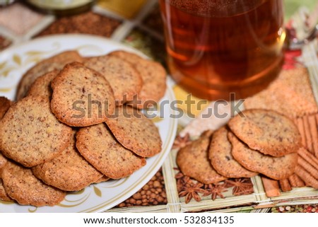ginger biscuits with tea and jar of jam on a New Year's background