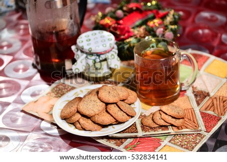 ginger biscuits with tea and jar of jam on a New Year's background