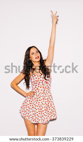 stock photo beautiful young brunette woman in a short summer dress lifted up her hand with a sign victory 373839229