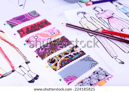 Sketches of clothes and fabric samples on table