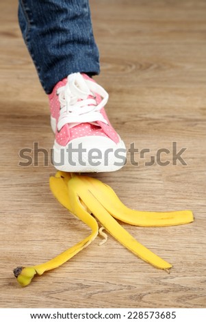 Shoe to slip on banana peel and have an accident - stock photo