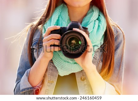 Young photographer taking photos outdoors