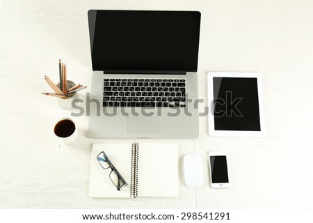 Laptop with tablet and smart phone on Workplace top view