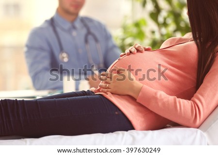 Pregnant woman with doctor at hospital